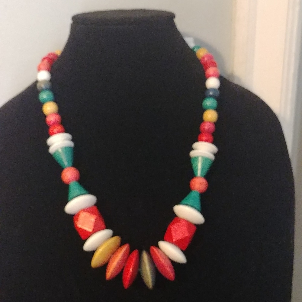 Multicolored wooden necklace with a variety of beaded shapes.